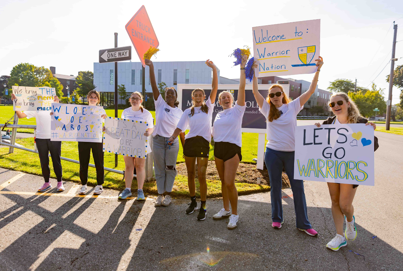 Students holding welcoming signs